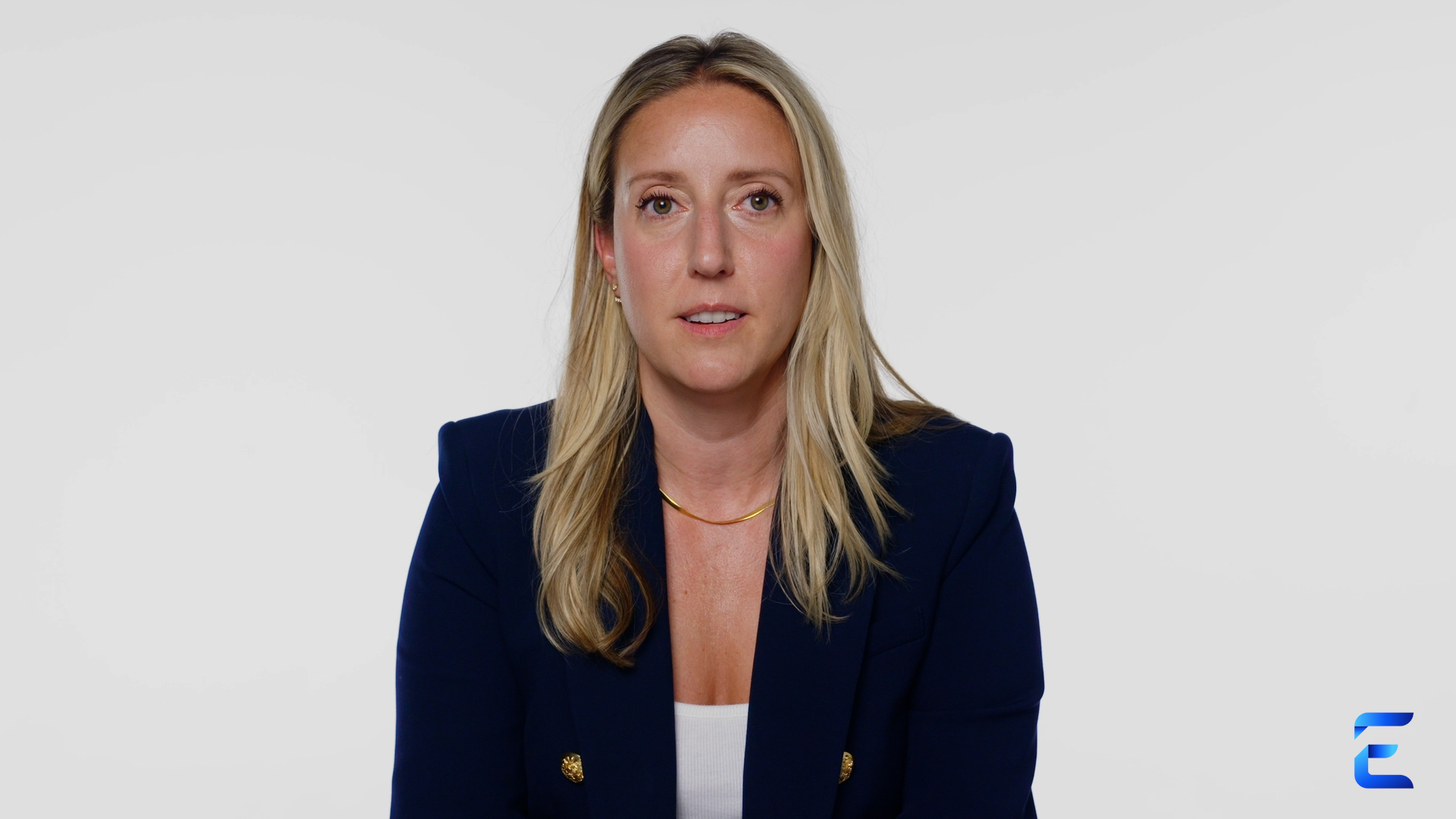 Alexandria Garripoli, Vice President of Product Management for Epsilon Retail Media, delivers her message directly to camera against a stark white background. She is wearing a blue blazer and white shirt.